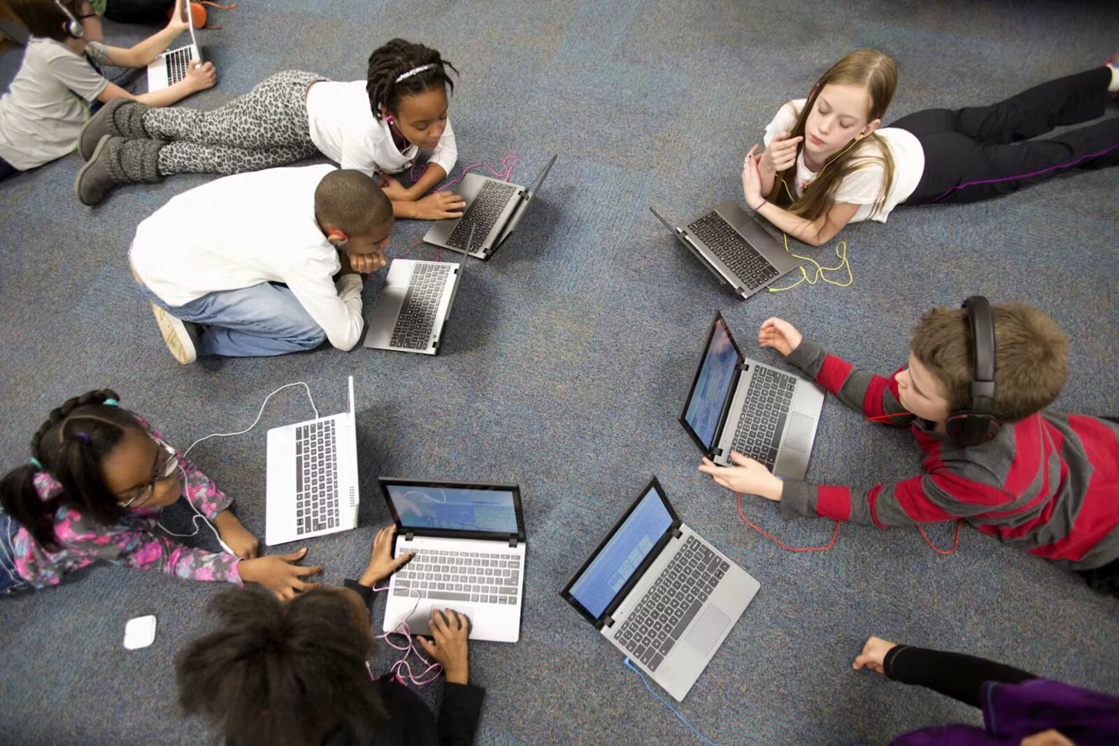 Students working together on laptops in a classroom